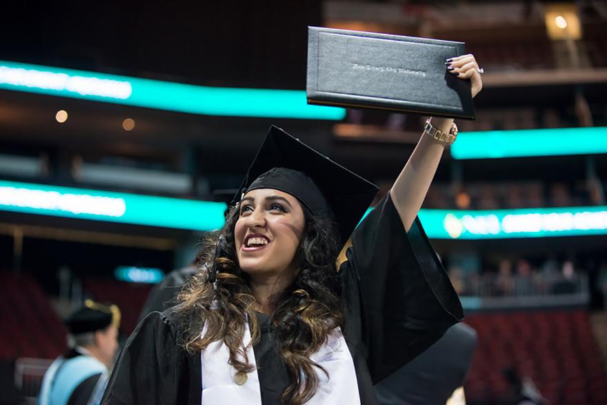 Graduate holding diploma